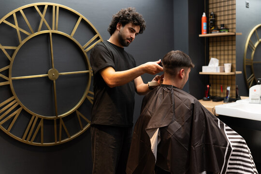 Barber giving client a fresh haircut in salon