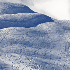 Hill covered by ski and snowboard tracks, Stoos ski area, SWitzerland.