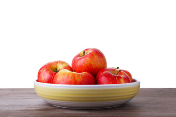 Ripe red apples in bowl on wooden table against white background, closeup