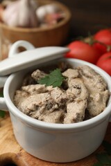 Tasty beef stroganoff with parsley served on wooden table, closeup