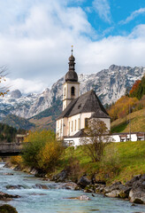 Alpine scenery on a sunny day of autumn with the St. Sebastian church