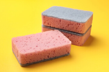 Clean kitchen sponges on yellow background, closeup