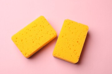Kitchen sponges on pink background, top view