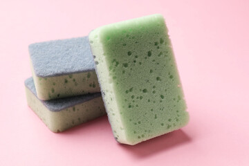 Clean kitchen sponges on pink background, closeup