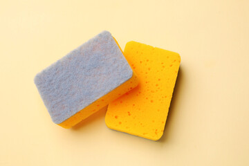 Kitchen sponges on beige background, top view