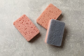 Clean kitchen sponges on grey table, flat lay