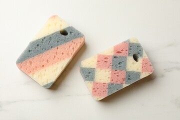 Kitchen sponges on white marble table, flat lay