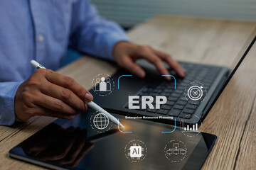 Business professional using pen pointing on tablet and laptop to manage ERP systems, highlighting AI, analytics, workflow optimization for modern enterprise resource planning solutions