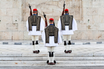Three members of the Presidential Guard soldiers (evzones) in the city center of the Greek capital, Athens, Greece. Concept of historical traditional ceremony of elite military.