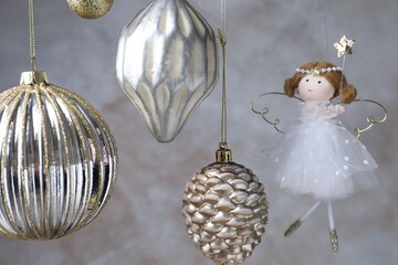 Fototapeta premium Beautiful Christmas decor hanging near light grey wall, closeup