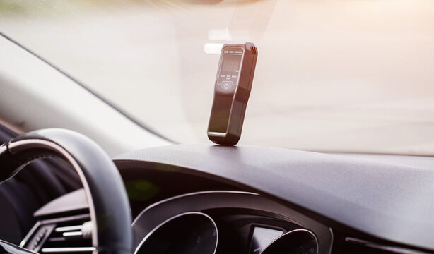 Breath Alcohol Analyzer On Car Dashboard In Sunlight. Device Ready For Driver Sobriety Check. Copy space for text