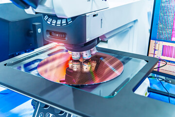 Silicon wafer with semiconductor microchip on machine process examining testing in microscope.