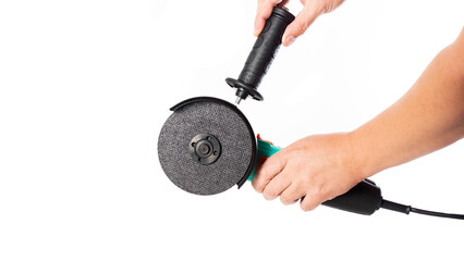 Modern angle grinder with a cutting wheel and an additional handle on a white background, isolate,...