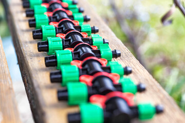 Obraz premium Multicolored plastic taps for assembling drip irrigation at the dacha, close-up