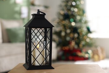Christmas lantern on wooden table against blurred lights, space for text. Bokeh effect