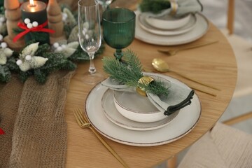 Festive table setting with Christmas decor indoors, closeup
