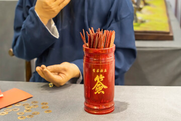 Obraz premium Bamboo cylinder with fortune sticks,Shake to predict the future,top side chinese text translation:Grant whatever is requested,down side chinese text mean:fortune sticks