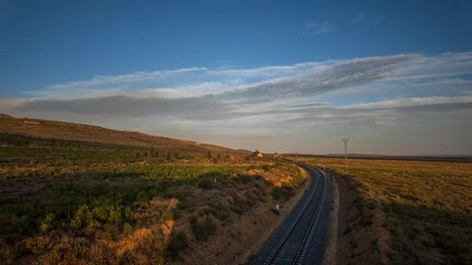 Timelapse dusk over wild desolate railway track in inhospitable landscape