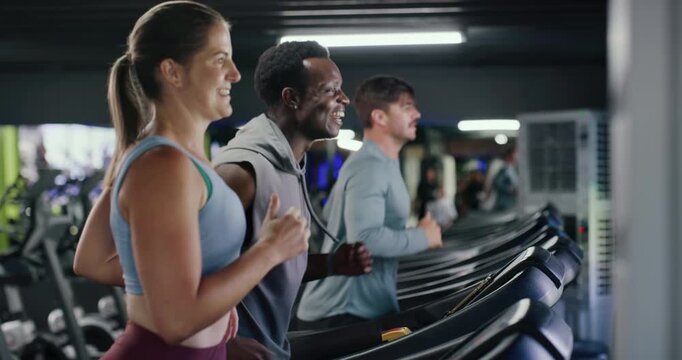 People, running and treadmill in gym for workout, athlete training and endurance for health. Cardio, personal trainer and machine with female runner, exercise and smile for wellness at fitness center