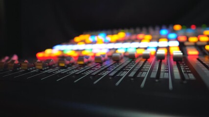 Close up of moving buttons on dj remote or soundboard. Working process in recording studio. Blurred dark background with brightly glow keys. Musical player at night party. Dolly shot Slow motion - Powered by Adobe