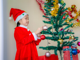 Happy a little girl with Xmas morning in decorated living room.Christmas