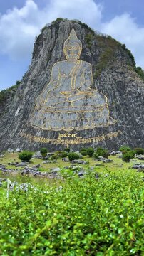CHONBURI, Thailand - June 9, 2025: The Golden Buddha Mountain. The Buddha image carved into the rock of Khao Chi Chan, Khao Chion, Pattaya, engraved in gold,on a hill dedicated to His Majesty the King