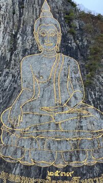 CHONBURI, Thailand - June 9, 2025: The Golden Buddha Mountain. The Buddha image carved into the rock of Khao Chi Chan, Khao Chion, Pattaya, engraved in gold,on a hill dedicated to His Majesty the King