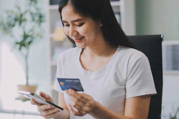 Online payment, Hands of woman holding a credit card and using smart phone for online shopping