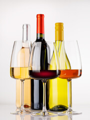 Naklejka premium Different wine bottles and glasses on white background