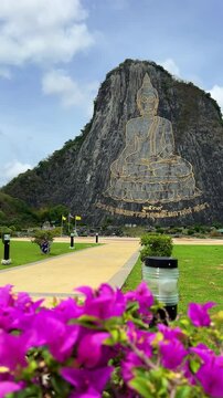 CHONBURI, Thailand - June 9, 2025: The Golden Buddha Mountain. The Buddha image carved into the rock of Khao Chi Chan, Khao Chion, Pattaya, engraved in gold,on a hill dedicated to His Majesty the King