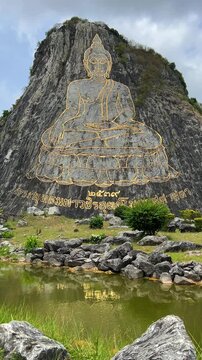 CHONBURI, Thailand - June 9, 2025: The Golden Buddha Mountain. The Buddha image carved into the rock of Khao Chi Chan, Khao Chion, Pattaya, engraved in gold,on a hill dedicated to His Majesty the King