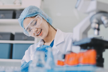 Portrait, science and happy woman on laptop in lab to research chemistry, test or innovation....