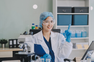 Portrait, science and happy woman on laptop in lab to research chemistry, test or innovation....