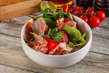 Salad with jamon, strawberry and arugula
