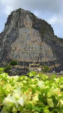 CHONBURI, Thailand - June 9, 2025: The Golden Buddha Mountain. The Buddha image carved into the rock of Khao Chi Chan, Khao Chion, Pattaya, engraved in gold,on a hill dedicated to His Majesty the King