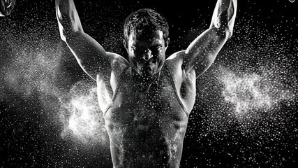 Intense weightlifter performing a heavy lift with chalk dust flying