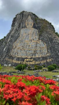 CHONBURI, Thailand - June 9, 2025: The Golden Buddha Mountain. The Buddha image carved into the rock of Khao Chi Chan, Khao Chion, Pattaya, engraved in gold,on a hill dedicated to His Majesty the King
