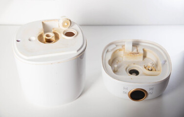 Dirty humidifier from hard water and mold. Hard water and scale, rust in white humidifier, close-up