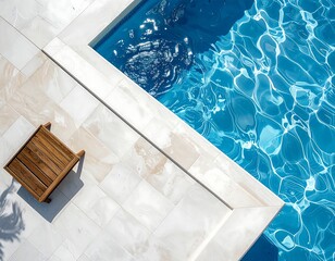 Serene Swimming Pool with Turquoise Water and Elegant Tile Surround and wooden chair