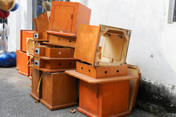 Pile of Discarded Orange Dining Tables on Street Side