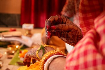 Bengali Hindu Wedding Ritual of Tying Sacred Yellow Thread on Bride’s Hand