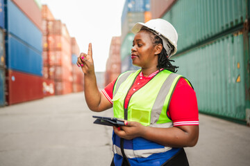 A professional female staff member in a shipping yard uses a digital device and gestures as if accessing virtual data. Ideal for concepts of smart logistics, cargo operations, workflow efficiency.