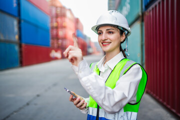 A white logistics engineer interacts with an invisible digital panel, symbolizing data analysis, cargo monitoring, and tech-driven supply chain solutions in a modern container yard.