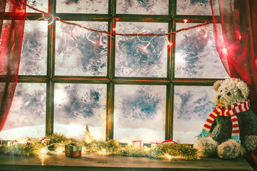 christmas cozy interior background with window sill illuminated with lights and bear toy