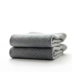 Two soft gray bath towels stacked neatly on a white background