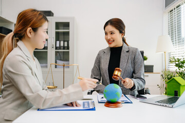 A lawyer presenting a green house model and earth globe with a gavel showing environmental law eco policy sustainability justice