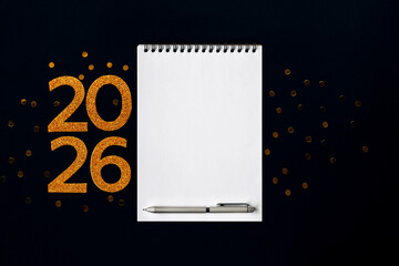 2026 New Year concept with empty notebook for your goals, plans, resolutions. Flat lay style. Christmas planning concept with space for text