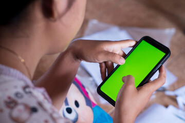 Close-Up Girl Holding Smartphone with Scattered Papers on the Floor