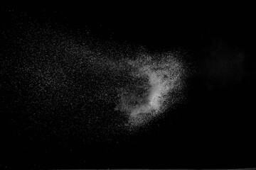 The falling white snow on a black background