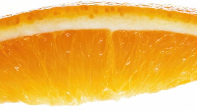 Video A detailed shot of a single orange slice with its texture and color prominent